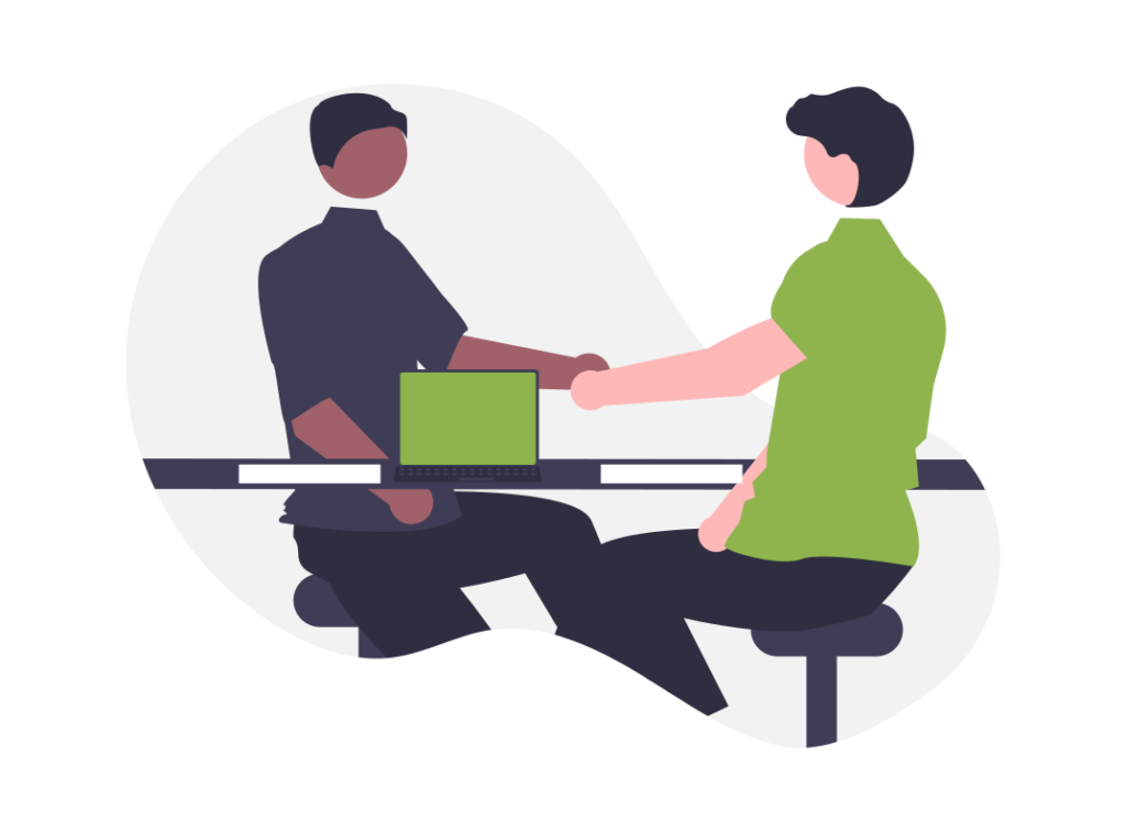 Man and woman shaking hands across desk
